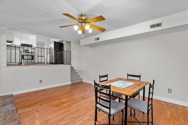172 Creek View Ct, Martinez, GA 30907 - dining area with ceiling fan, light wood finished floors, stairway, and a textured ceiling