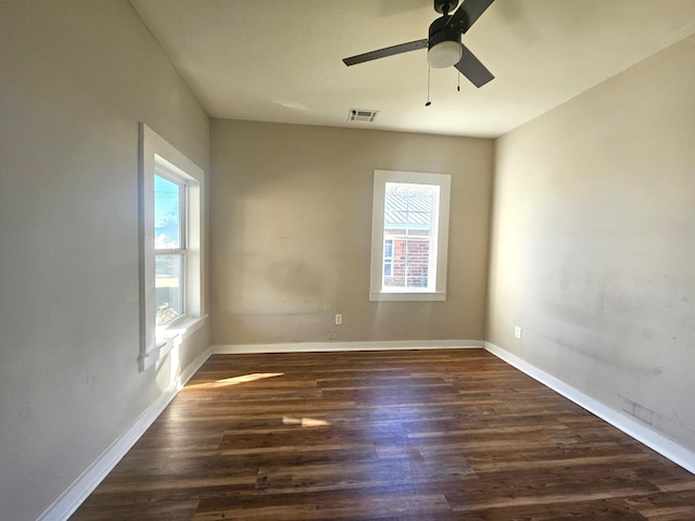 unfurnished room featuring ceiling fan, plenty of natural light, and dark hardwood / wood-style floors