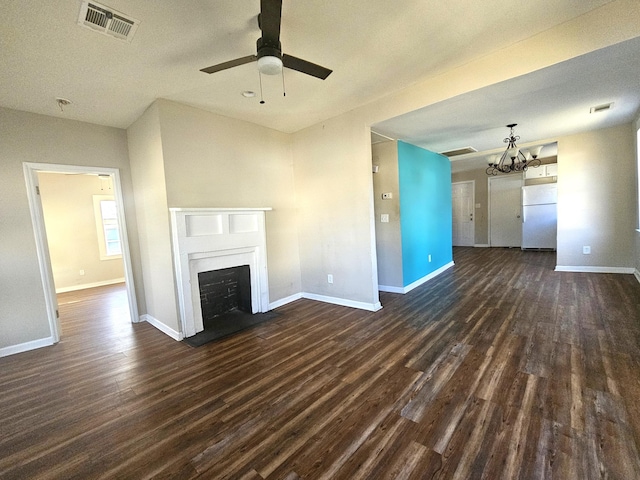 unfurnished living room featuring dark hardwood / wood-style floors and ceiling fan with notable chandelier