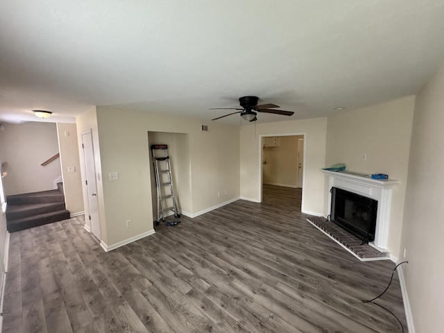 2227 Birnam Pl, Augusta, GA 30904 - unfurnished living room featuring dark wood-type flooring, a ceiling fan, stairway, and a fireplace with raised hearth