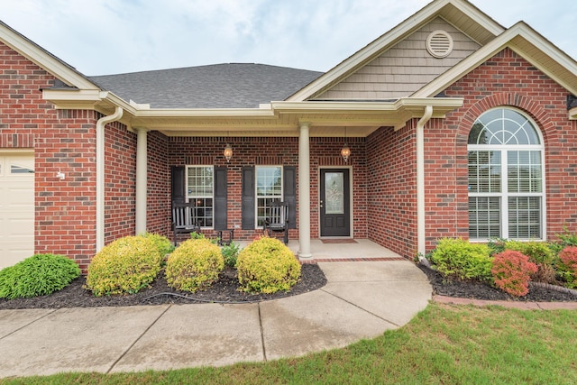 821 Wickham Dr, Graniteville, SC 29829 - entrance to property with a porch, brick siding, a shingled roof, and an attached garage