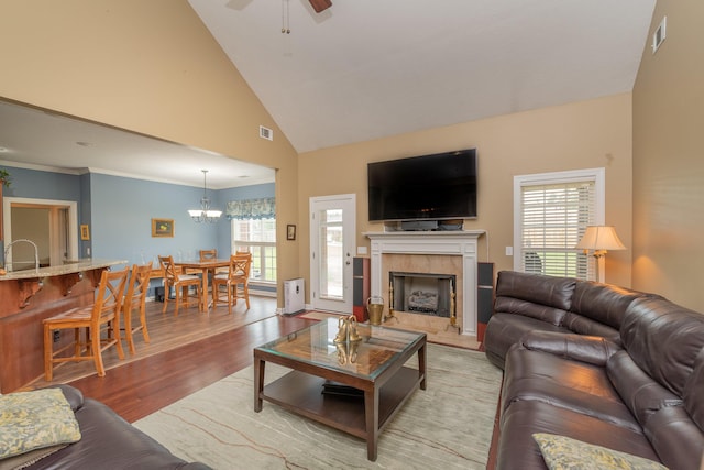 821 Wickham Dr, Graniteville, SC 29829 - living room with light wood-style flooring, a chandelier, a high end fireplace, high vaulted ceiling, and a ceiling fan