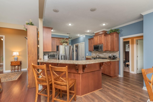 821 Wickham Dr, Graniteville, SC 29829 - kitchen featuring stainless steel appliances, tasteful backsplash, brown cabinetry, crown molding, and a peninsula
