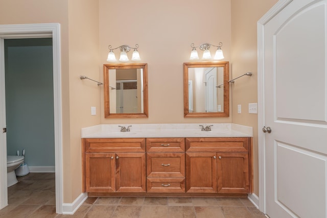 821 Wickham Dr, Graniteville, SC 29829 - bathroom featuring toilet, double vanity, and baseboards
