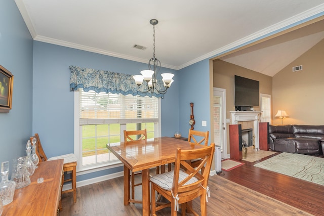 821 Wickham Dr, Graniteville, SC 29829 - dining space with a chandelier, wood finished floors, a fireplace, crown molding, and baseboards
