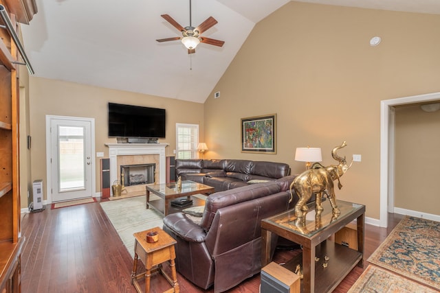 821 Wickham Dr, Graniteville, SC 29829 - living room featuring a ceiling fan, high vaulted ceiling, a tile fireplace, dark wood-type flooring, and baseboards