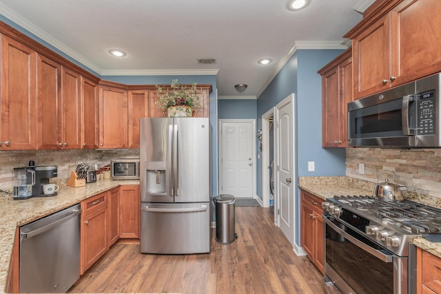 821 Wickham Dr, Graniteville, SC 29829 - kitchen featuring stainless steel appliances, ornamental molding, wood finished floors, decorative backsplash, and recessed lighting
