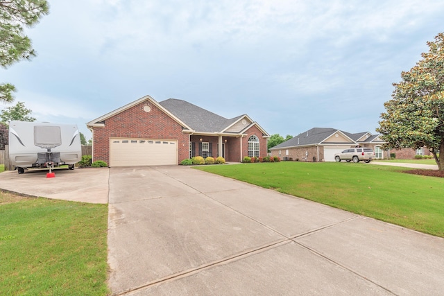821 Wickham Dr, Graniteville, SC 29829 - view of front facade featuring brick siding, a front yard, a garage, and concrete driveway