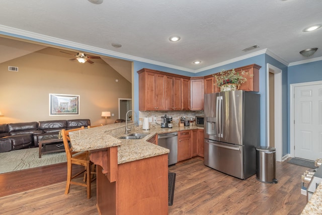 821 Wickham Dr, Graniteville, SC 29829 - kitchen with stainless steel appliances, a peninsula, open floor plan, a sink, and ornamental molding