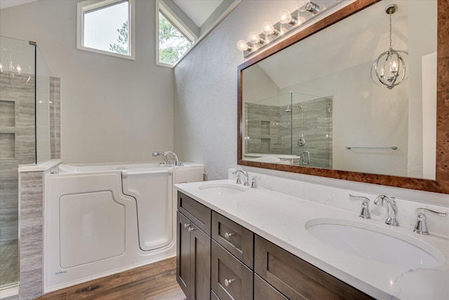 786 Springbrook Ln, Evans, GA 30809 - bathroom featuring a bath, a stall shower, a chandelier, double vanity, and wood finished floors