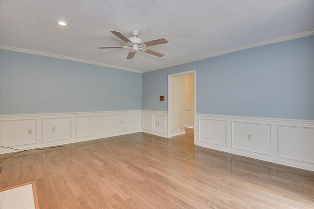 786 Springbrook Ln, Evans, GA 30809 - empty room featuring a ceiling fan, wainscoting, wood finished floors, ornamental molding, and a decorative wall