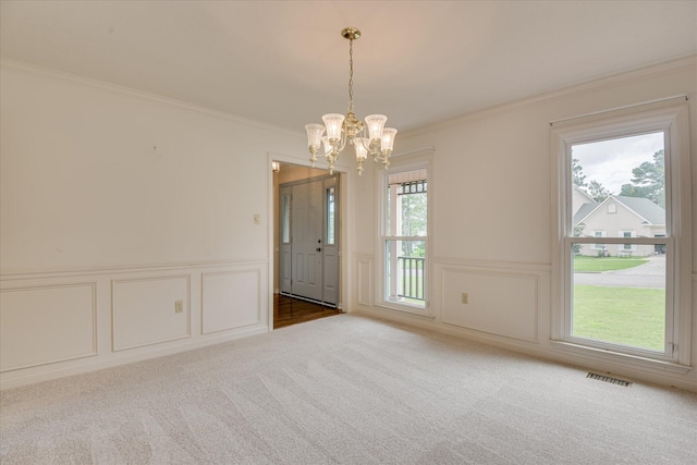 786 Springbrook Ln, Evans, GA 30809 - spare room featuring a decorative wall, crown molding, a chandelier, carpet floors, and wainscoting