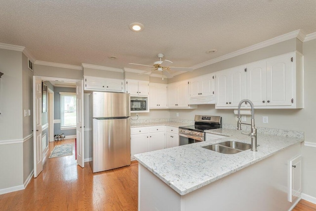 345 Old Salem Way, Martinez, GA 30907 - kitchen featuring appliances with stainless steel finishes, a peninsula, light stone counters, white cabinetry, and ornamental molding