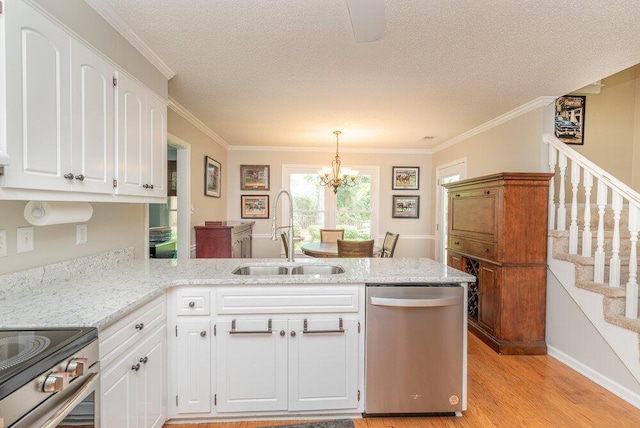345 Old Salem Way, Martinez, GA 30907 - kitchen with stainless steel appliances, a peninsula, light wood finished floors, white cabinetry, and a chandelier