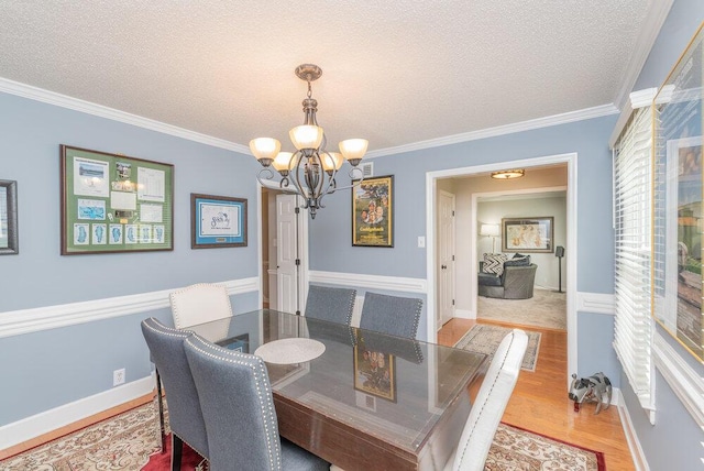 345 Old Salem Way, Martinez, GA 30907 - dining area with a chandelier, a textured ceiling, wood finished floors, and crown molding