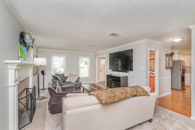 345 Old Salem Way, Martinez, GA 30907 - living area with ornamental molding, light wood-style floors, a textured ceiling, and a brick fireplace