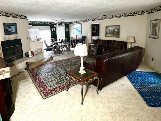 6322 Yelton Rd, Appling, GA 30802 - living room with a textured ceiling, a glass covered fireplace, and ceiling fan