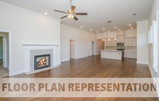 unfurnished living room featuring a tiled fireplace, crown molding, dark wood finished floors, and visible vents