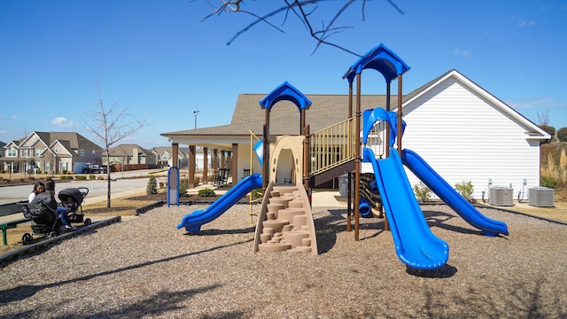 community jungle gym with a residential view and central AC unit