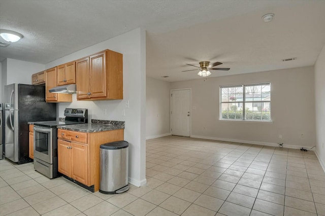 kitchen with appliances with stainless steel finishes, light tile patterned floors, a textured ceiling, and ceiling fan