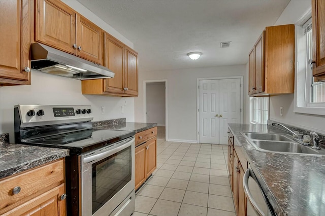 kitchen with sink, light tile patterned floors, and stainless steel appliances