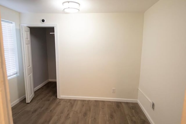 unfurnished room with baseboards and wood finished floors