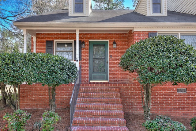 property entrance with brick siding