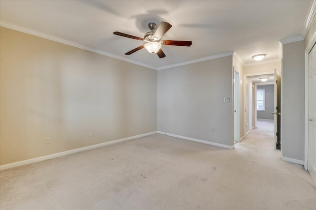 unfurnished room featuring baseboards, ornamental molding, a ceiling fan, and light colored carpet