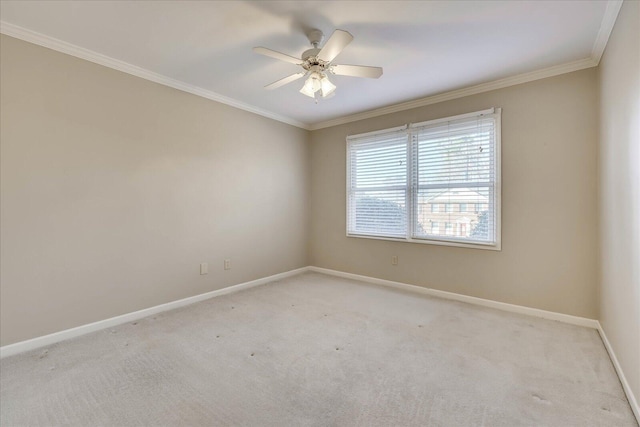 unfurnished room with light carpet, ceiling fan, baseboards, and crown molding