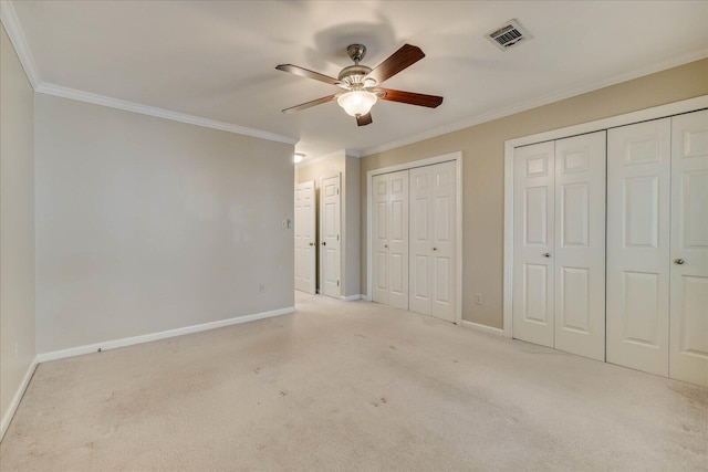 unfurnished bedroom with baseboards, visible vents, and crown molding