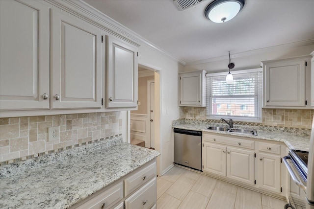 kitchen with crown molding, stainless steel appliances, tasteful backsplash, a sink, and light stone countertops