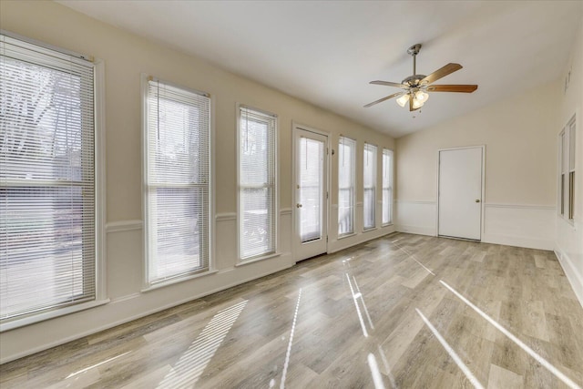 spare room with vaulted ceiling, ceiling fan, and light wood finished floors