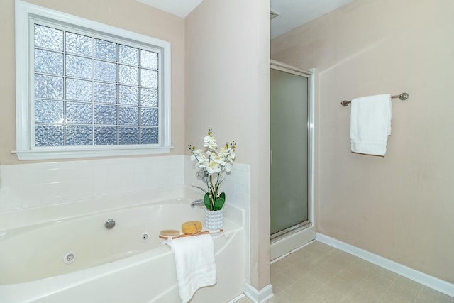 bathroom featuring shower with separate bathtub