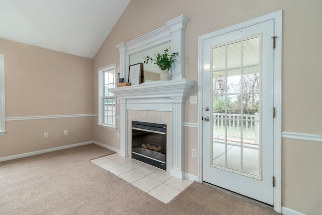 unfurnished living room featuring a tile fireplace, light carpet, and vaulted ceiling