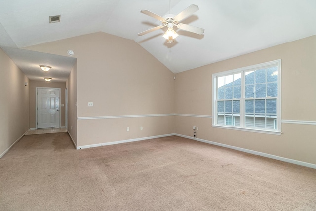 carpeted empty room with ceiling fan and lofted ceiling