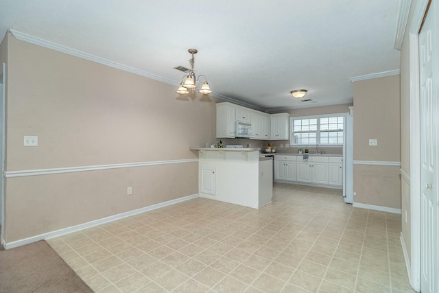 kitchen with white appliances, white cabinets, decorative light fixtures, and ornamental molding