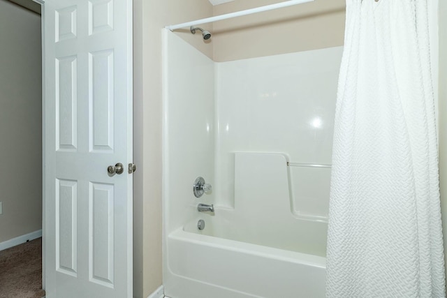 bathroom with shower / bath combo with shower curtain