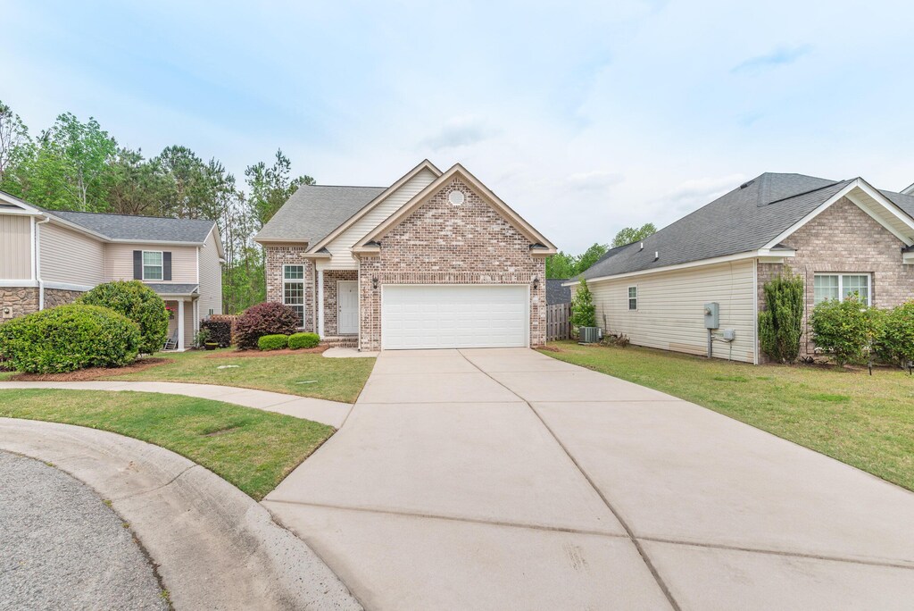 3305 Bingham Ct, Augusta, GA 30909 - single story home with driveway, brick siding, a front yard, and a garage