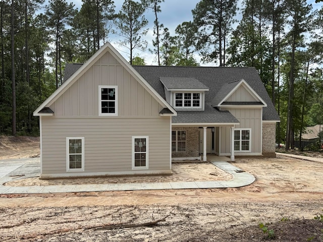 5015 Charnwood Forest Cir, Aiken, SC 29803 - back of property with a shingled roof, board and batten siding, a patio area, and brick siding