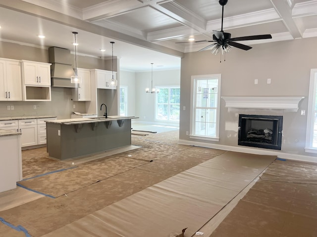 5015 Charnwood Forest Cir, Aiken, SC 29803 - kitchen with custom exhaust hood, crown molding, ceiling fan, open floor plan, and an island with sink
