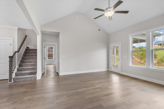 unfurnished living room with hardwood / wood-style flooring, high vaulted ceiling, and ceiling fan