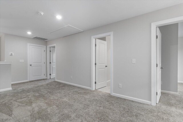 unfurnished room featuring light colored carpet