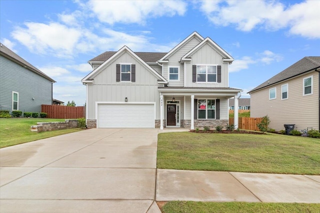 craftsman house with a front yard and a garage