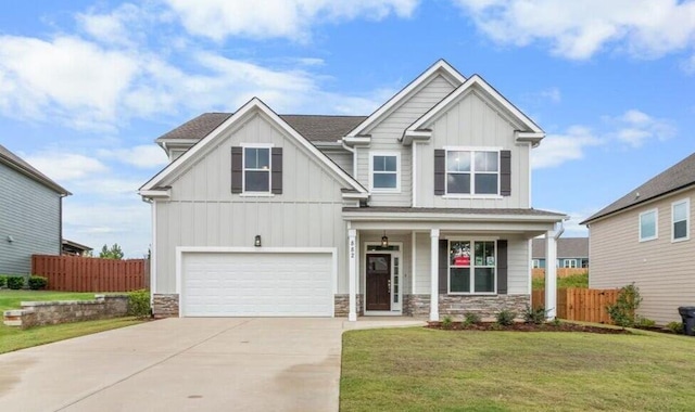 craftsman-style home featuring a garage, a porch, and a front yard