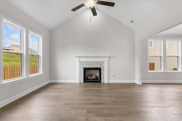 unfurnished living room featuring hardwood / wood-style flooring, high vaulted ceiling, and ceiling fan