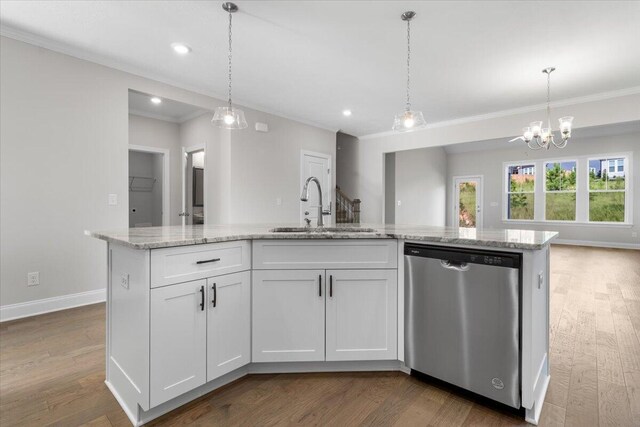 kitchen with sink, hanging light fixtures, a center island with sink, stainless steel dishwasher, and white cabinets