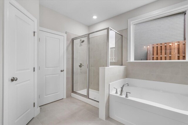 bathroom featuring separate shower and tub and tile patterned flooring