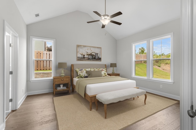 bedroom with lofted ceiling, ceiling fan, and light hardwood / wood-style flooring