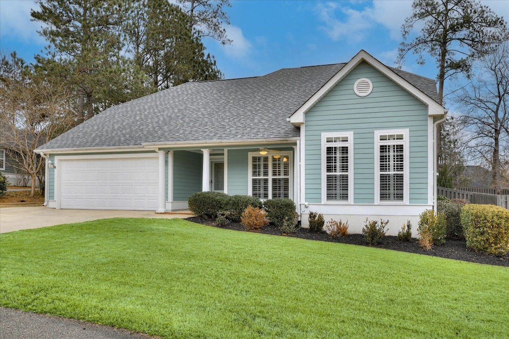 ranch-style home featuring a front lawn and a garage