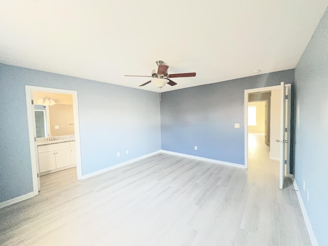 unfurnished bedroom with ensuite bath, ceiling fan, and light hardwood / wood-style flooring